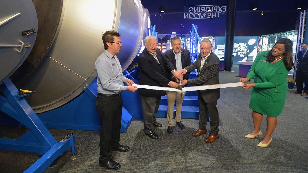 Jeff Siders, HALO (Habitation and Logistics Outpost) program and business development manager at Northrop Grumman; president and CEO of Space Center Houston William Harris; and Sean Fuller, international partner manager for the Gateway program at NASA cut a ribbon ceremonially opening the lunar habitat exhibit at Space Center Houston on Oct. 23, 2024. 